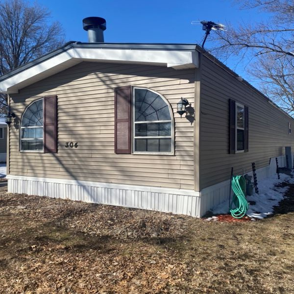 This picture shows a 2nd image of the front and a bit of the side of the home.