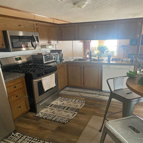 This is a beautiful eat in kitchen. That window really brightens this space up well.