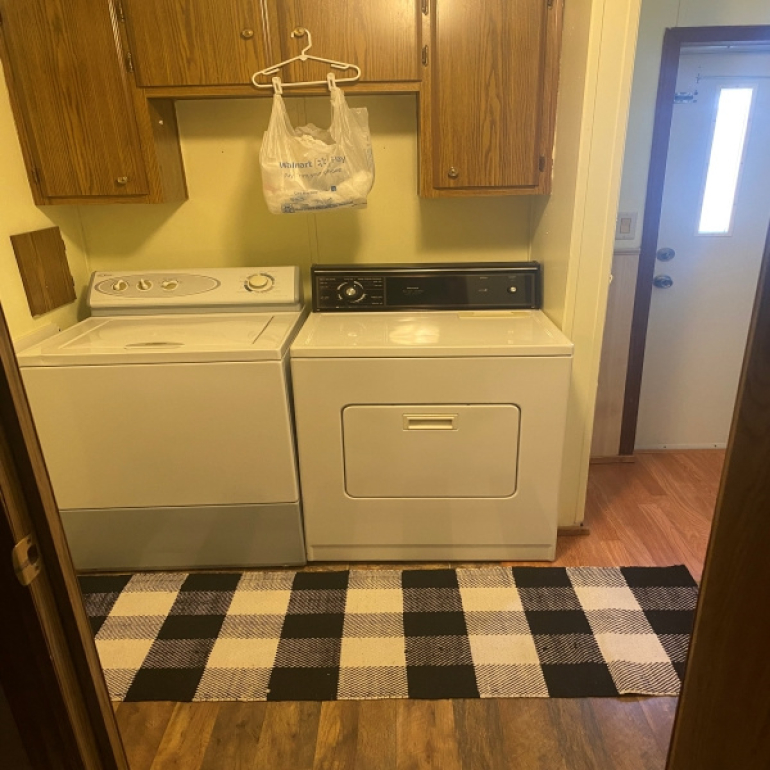 Imagine doing your laundry in this space. Good storage and lighting make this an excellent place to do your work in.