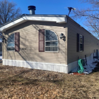 This picture shows a 2nd image of the front and a bit of the side of the home.