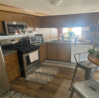 This is a beautiful eat in kitchen. That window really brightens this space up well.